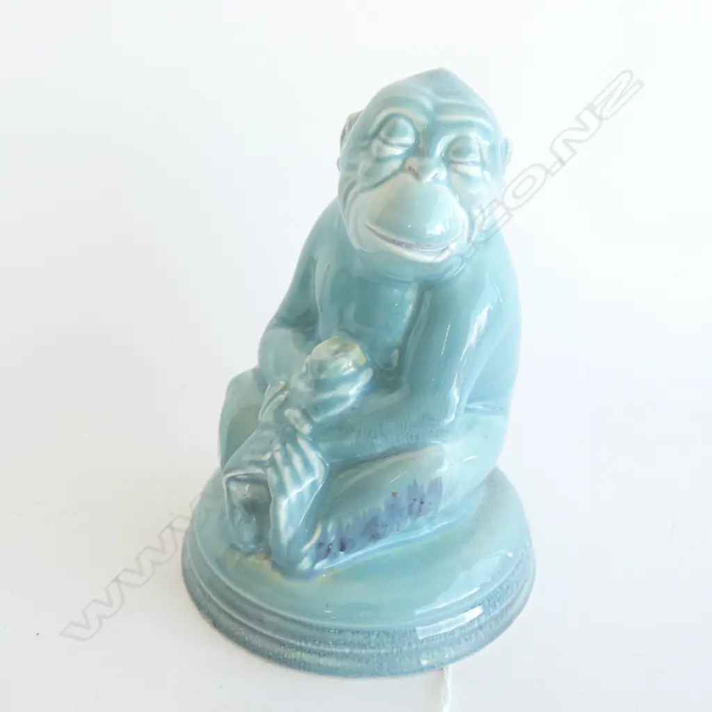 A Beswick monkey holding a piece of fruit Image 1++